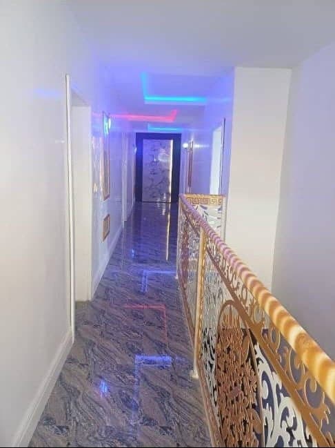 Marble corridor with an ornate gold balustrade at Kal Vegas Hotel & Suites, Calabar